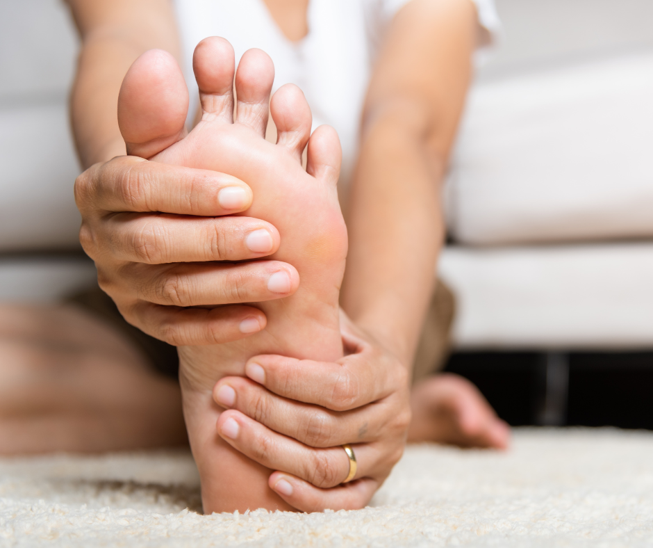 person holding foot with nerve pain