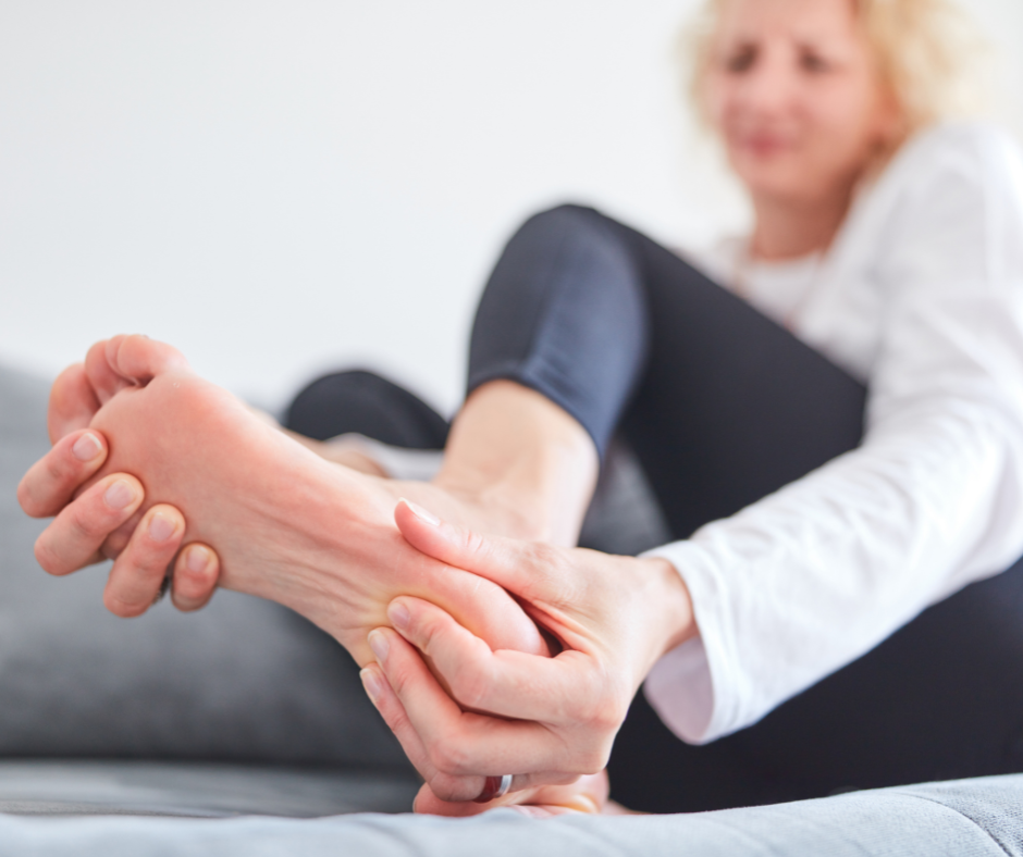 woman holding foot in pain