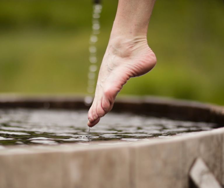a person stepping into an ice bath